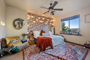 Bedroom with baseboards, visible vents, a ceiling fan, a textured ceiling, and carpet floors