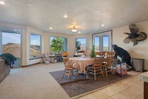 Dining space featuring a textured ceiling, french doors, a wealth of natural light, and recessed lighting