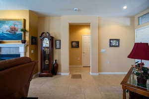 Hallway  to bedrooms with light tile patterned floors, recessed lighting, and baseboards