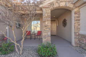 Entrance to property featuring stone siding and stucco siding