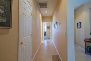 Hallway to 2nd bed and bath featuring visible vents, baseboards, and light tile patterned floors