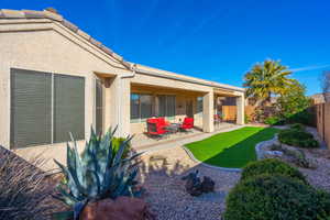 Back of property featuring a patio area, a fenced backyard, and stucco siding