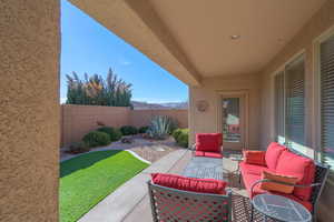 View of patio with an outdoor hangout area and a fenced backyard