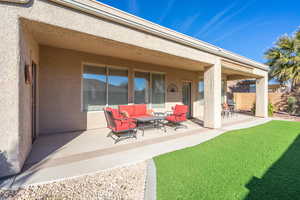 View of patio featuring an outdoor hangout area and fence