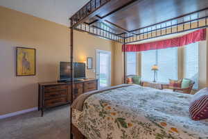 Carpeted bedroom featuring baseboards