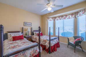 2nd Bedroom featuring carpet flooring, bay window, ceiling fan, and baseboards