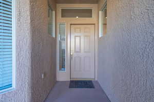 View of exterior entry with stucco siding