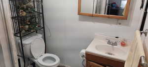 Half bathroom with vanity and toilet