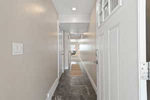 Hallway with visible vents and baseboards