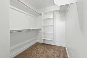 Walk in closet located in the primary bedroom.