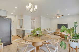 Dining area with light wood-type flooring, a ceiling fan, and recessed lighting