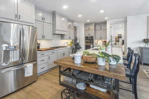 Kitchen with stainless steel appliances, gray cabinets, and a sink