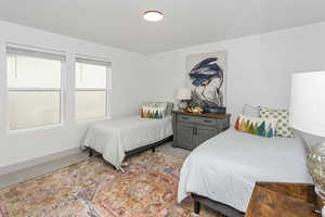 Bedroom featuring baseboards and light colored carpet