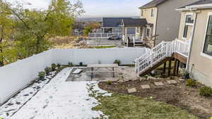 View of yard featuring a fenced backyard, a deck, and stairs