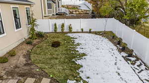 View of yard featuring a fenced backyard and a fire pit