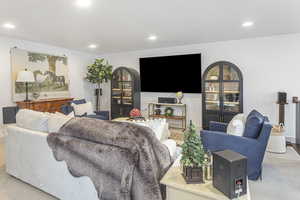 Living room featuring recessed lighting and light carpet