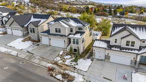 Snowy aerial view with a residential view and a mountain view