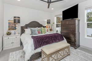 Bedroom featuring ceiling fan, baseboards, light colored carpet, and recessed lighting