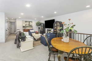 Dining room with light carpet and recessed lighting