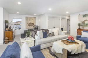 Living room featuring baseboards and recessed lighting