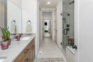 Full bath featuring recessed lighting, a shower stall, visible vents, and vanity