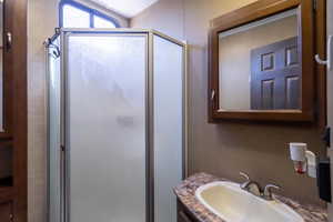 Bathroom featuring a stall shower and vanity