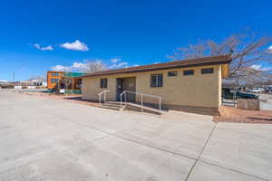 Ranch-style house featuring stucco siding