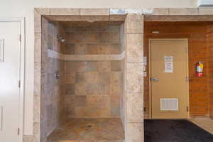 Bathroom with a stall shower and visible vents