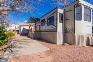 View of home's exterior with a patio and a shed