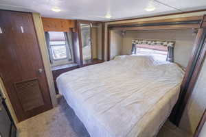 Carpeted bedroom featuring visible vents