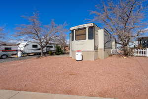 View of outbuilding featuring fence