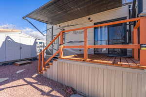 Exterior space featuring a storage shed and an outbuilding