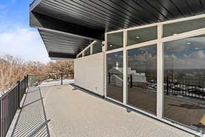 View of exterior of home and covered deck.