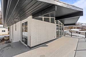 View of exterior of home and covered deck.