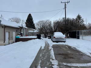 Snowy yard featuring fence