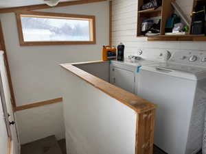 Laundry area with laundry area, washer and clothes dryer, and baseboards