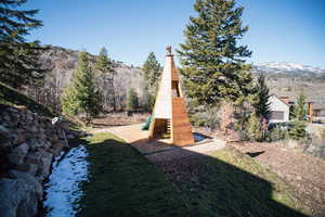View of yard featuring a mountain view and a playground