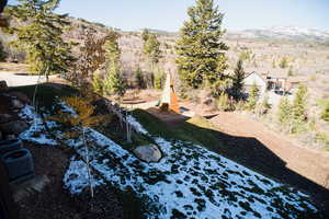 View of yard with central AC unit and a mountain view