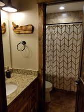 Full bath with a shower with shower curtain, vanity, and toilet