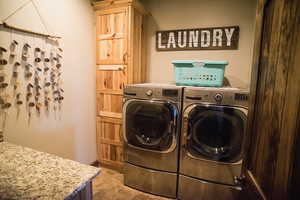 Washroom featuring cabinet space and washing machine and clothes dryer