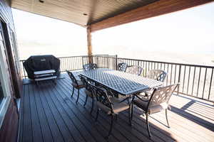 Wooden deck with outdoor dining area and grilling area