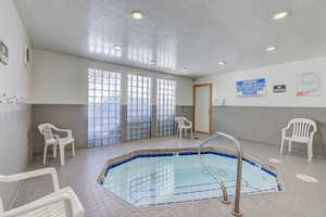 View of pool with an indoor in ground hot tub