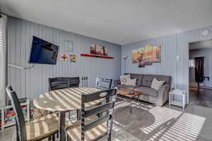 Living room with a textured ceiling and wood finished floors