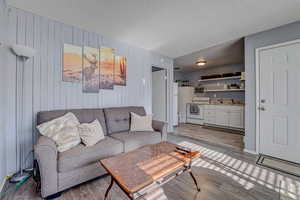 Living room featuring a textured ceiling and wood finished floors