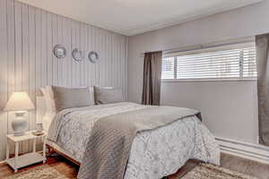 Bedroom with a textured ceiling and wood finished floors