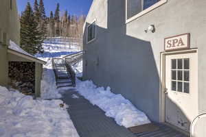 View of snow covered exterior featuring stucco siding