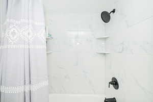 Bathroom with shower / tub combo with curtain