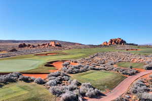 Bird's eye view with golf course view and a mountain view