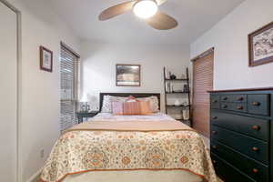 Bedroom featuring a ceiling fan and a closet