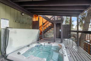 Wooden terrace with a covered hot tub